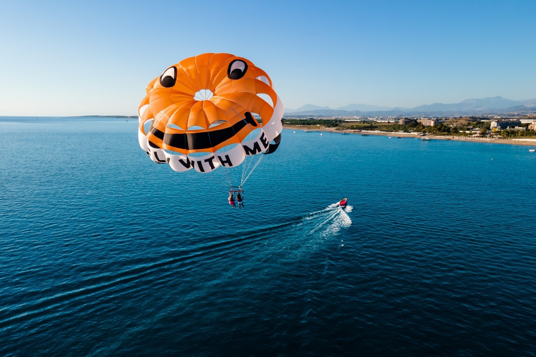 Parasailing in the clear blue sea at a luxury hotel resort, the ultimate vacation experience