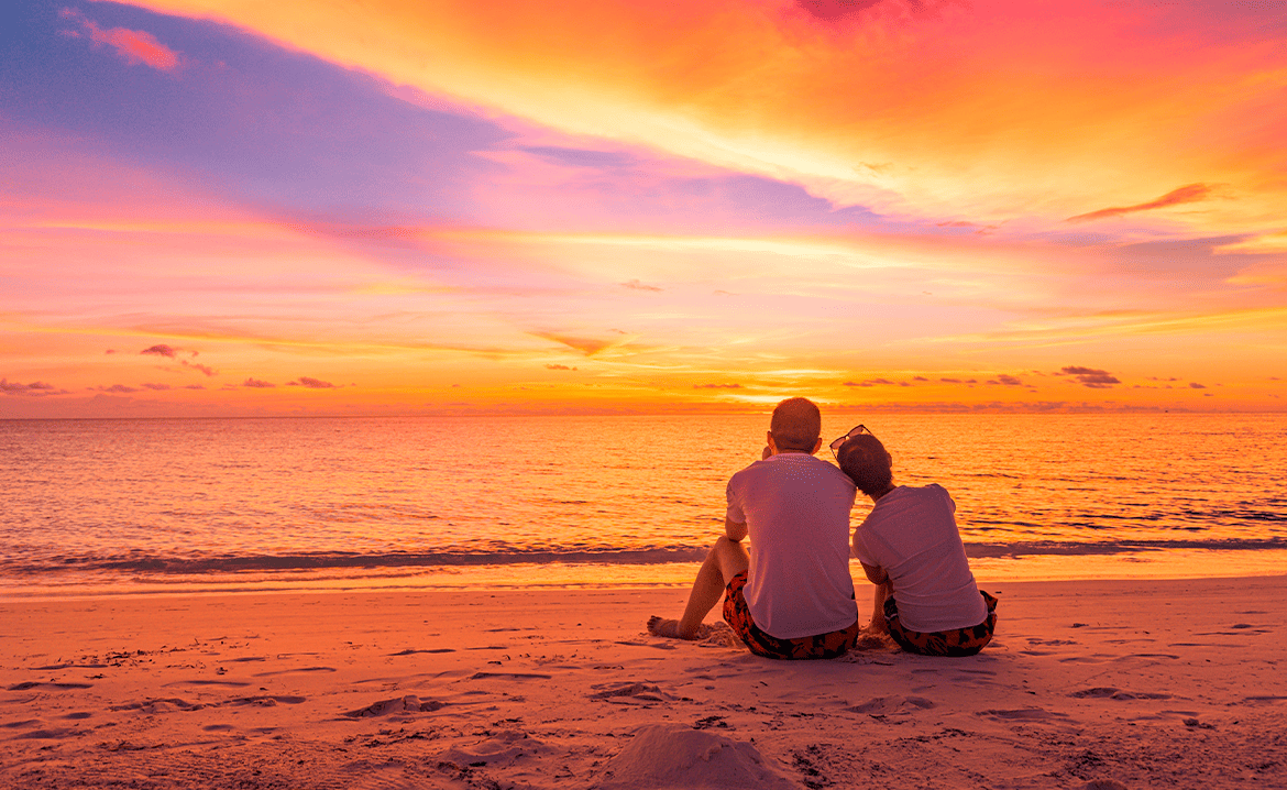 Couple watching sunset at South Padre Island beach